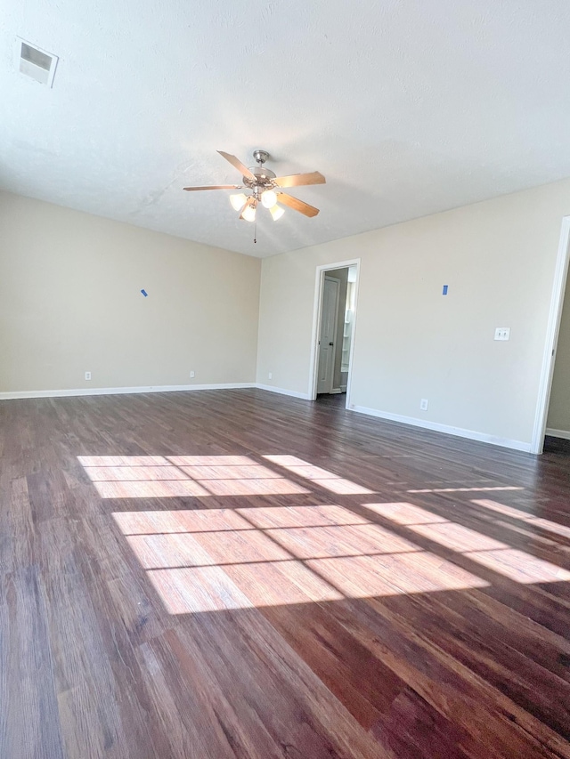 unfurnished room with ceiling fan and dark hardwood / wood-style floors