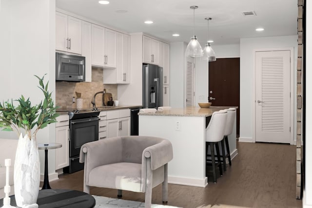 kitchen featuring range with electric cooktop, pendant lighting, white cabinets, a center island, and stainless steel refrigerator with ice dispenser