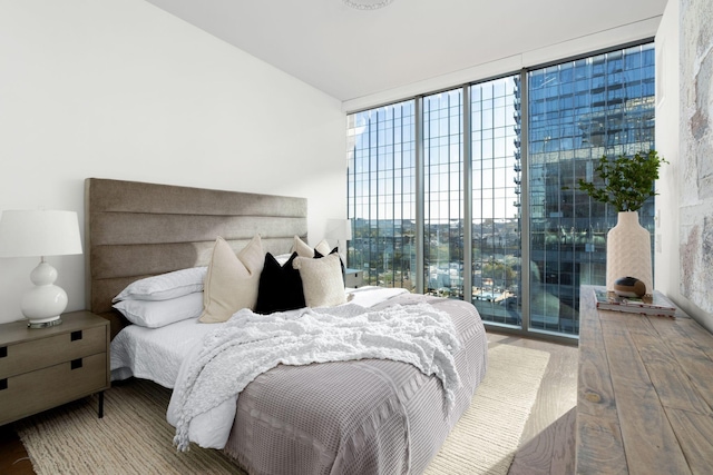 bedroom with hardwood / wood-style flooring and floor to ceiling windows