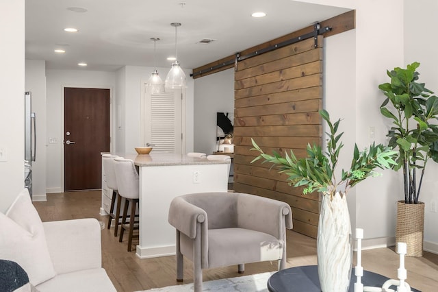 interior space featuring wood-type flooring and a barn door