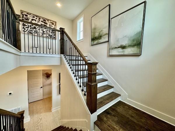 stairs featuring wood-type flooring