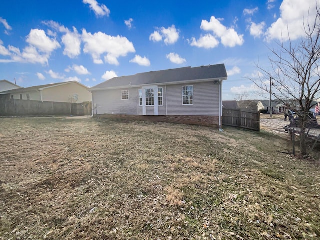 back of property with a lawn