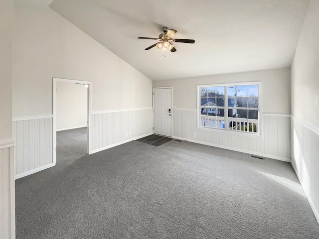 carpeted spare room featuring lofted ceiling and ceiling fan