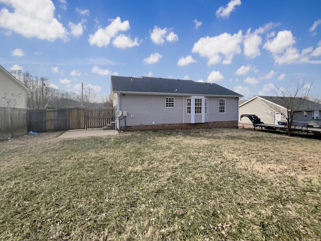 rear view of house featuring a yard and a patio area