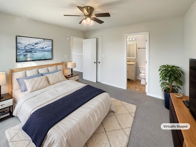 carpeted bedroom with ceiling fan and ensuite bathroom