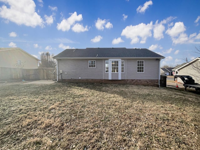 rear view of property with a yard