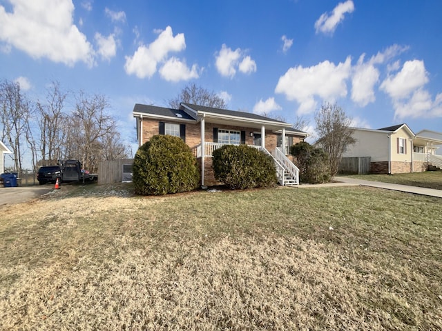 view of front of home with covered porch and a front lawn