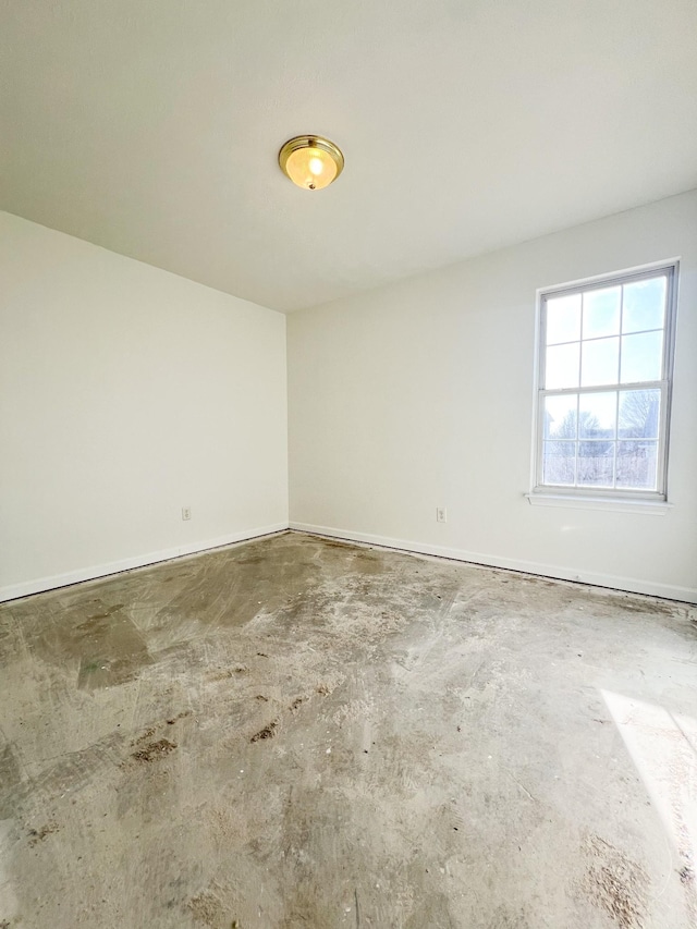 unfurnished room with concrete flooring