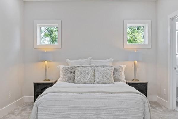 carpeted bedroom featuring multiple windows