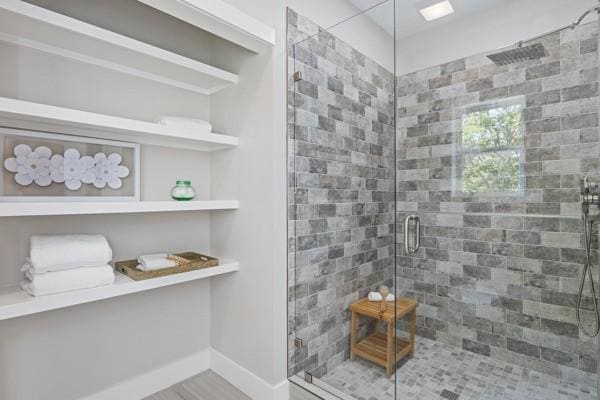 bathroom featuring a shower with door