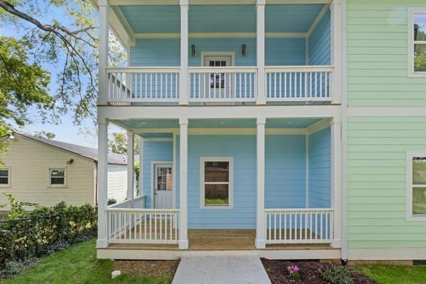 rear view of house featuring covered porch