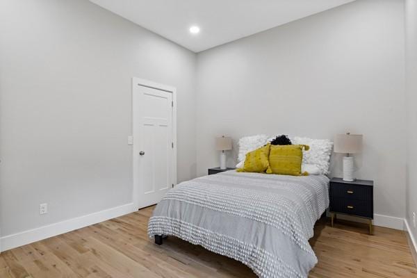 bedroom with recessed lighting, baseboards, and wood finished floors