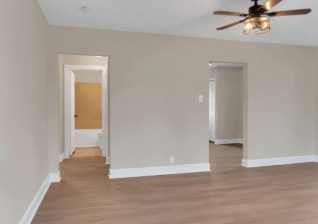 empty room featuring ceiling fan and light hardwood / wood-style floors