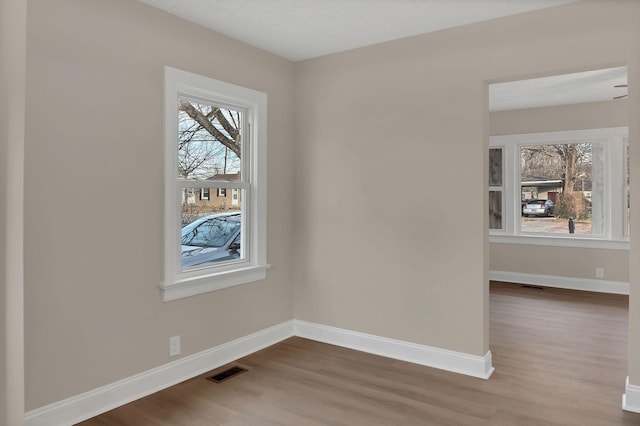 unfurnished room featuring wood-type flooring