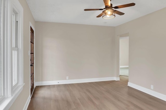 unfurnished room featuring ceiling fan and light hardwood / wood-style floors