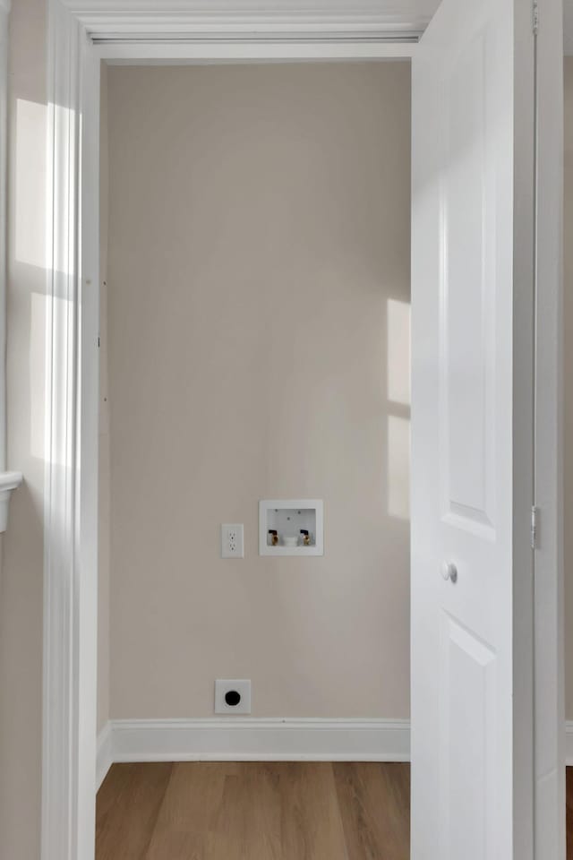 laundry area featuring hardwood / wood-style flooring, hookup for a washing machine, and electric dryer hookup