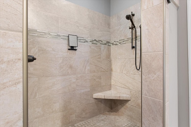 bathroom with a tile shower