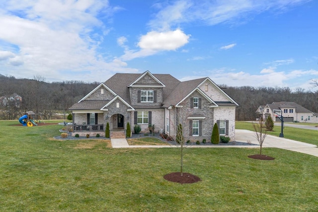 craftsman house with a porch, a playground, and a front yard