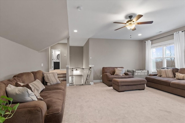 living room with lofted ceiling, carpet flooring, and ceiling fan