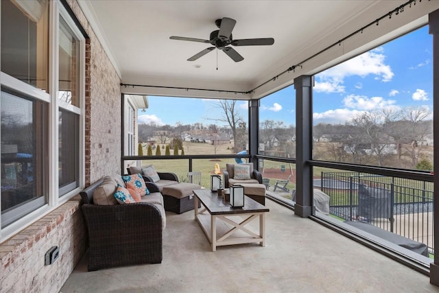 sunroom featuring ceiling fan