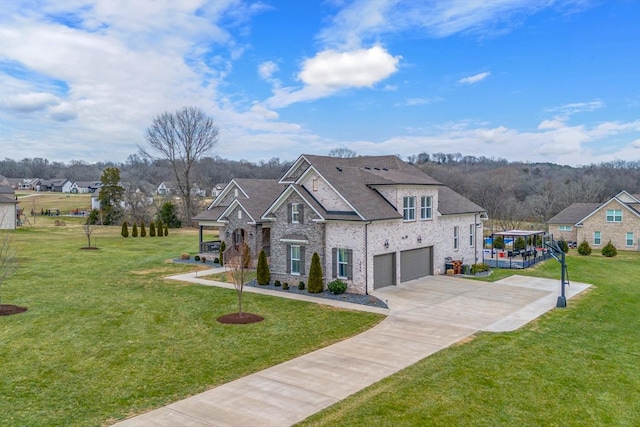 view of front of property with a garage and a front lawn