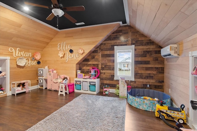 game room with lofted ceiling, a wall mounted air conditioner, wooden walls, and dark hardwood / wood-style flooring