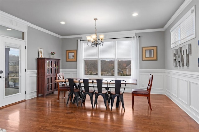 dining room with a notable chandelier, crown molding, and a healthy amount of sunlight