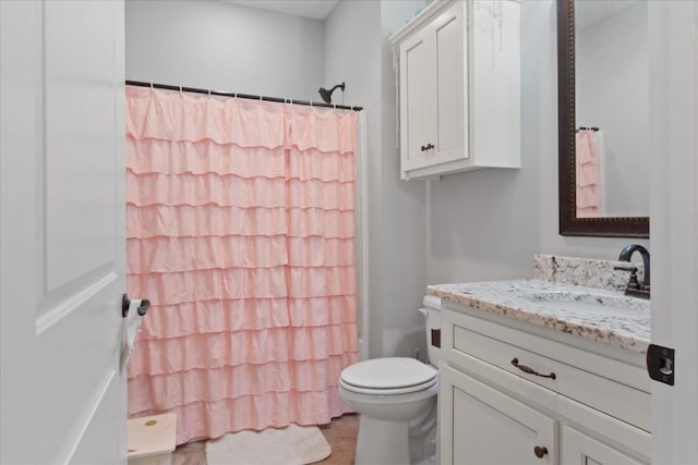 bathroom featuring vanity, toilet, and a shower with shower curtain