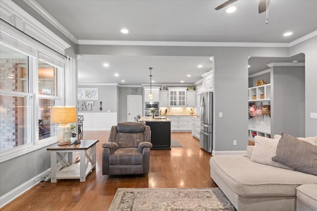 living room featuring ceiling fan, ornamental molding, and dark hardwood / wood-style flooring