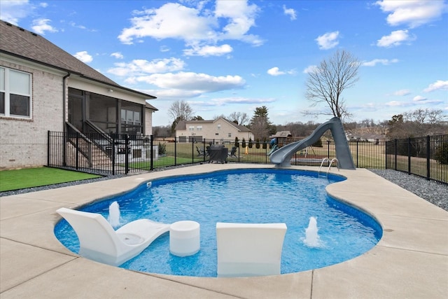 view of pool with a yard, a sunroom, and a water slide