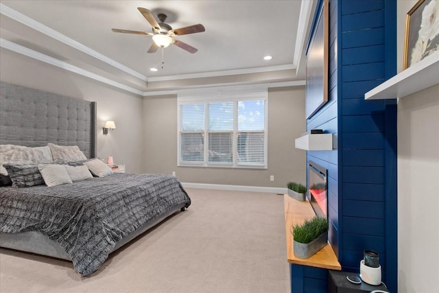 carpeted bedroom featuring ornamental molding, a raised ceiling, and ceiling fan