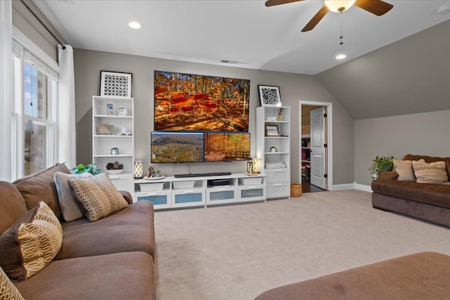 living room featuring carpet floors, vaulted ceiling, and ceiling fan