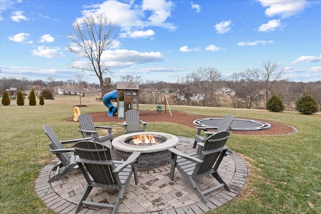 view of patio featuring a playground and a fire pit