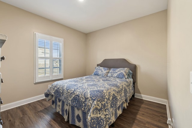 bedroom with dark wood-type flooring