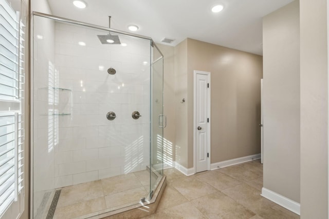 bathroom featuring a shower with door and tile patterned flooring