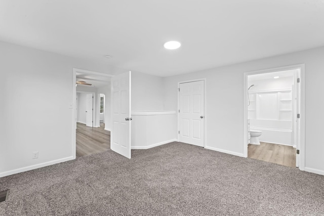 interior space with carpet flooring and ensuite bath