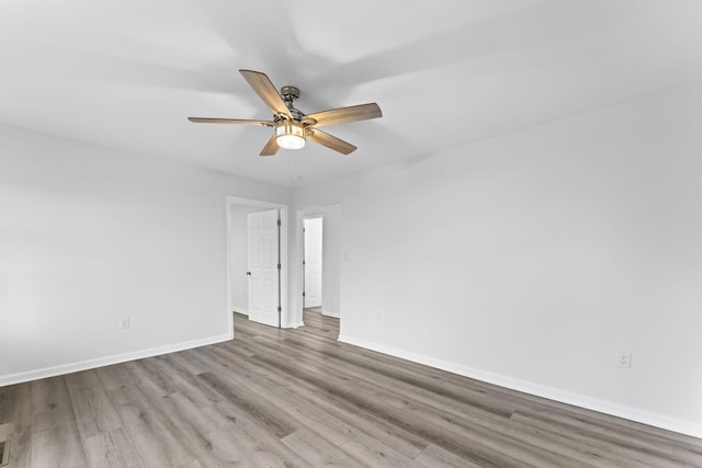 spare room featuring ceiling fan and light hardwood / wood-style flooring