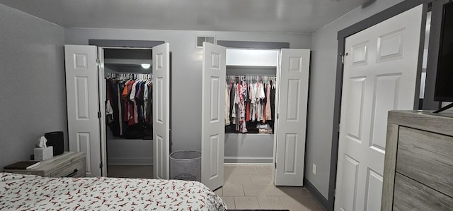 tiled bedroom featuring a closet