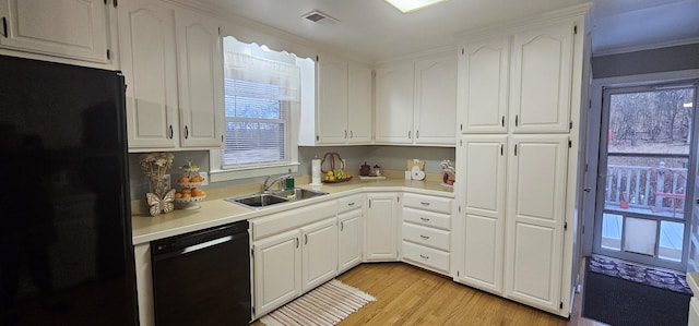 kitchen featuring white cabinetry, sink, light hardwood / wood-style flooring, and black appliances