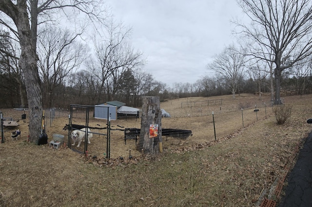 view of yard featuring an outbuilding and a rural view