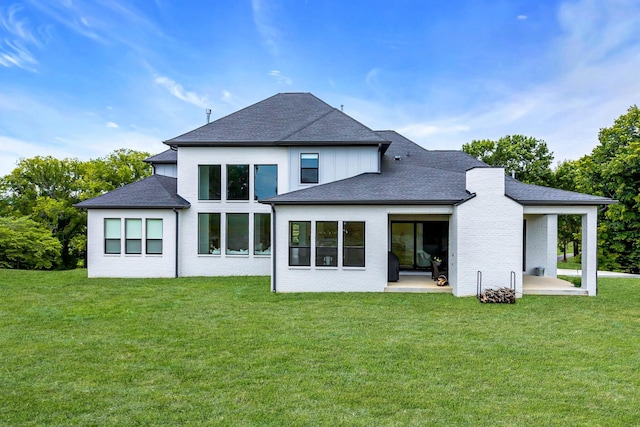 rear view of property with a yard and a patio