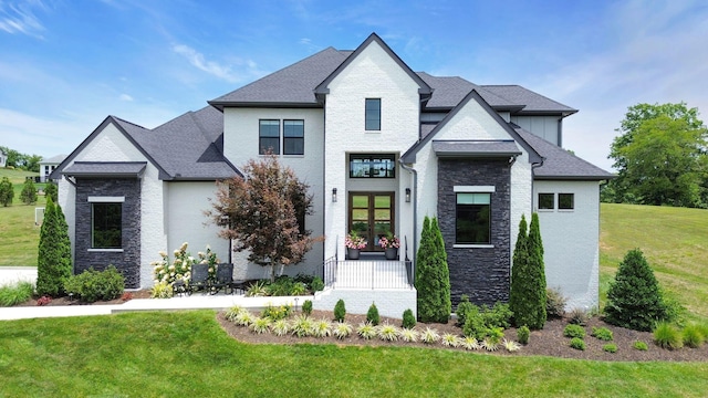 view of front facade featuring a front lawn and french doors