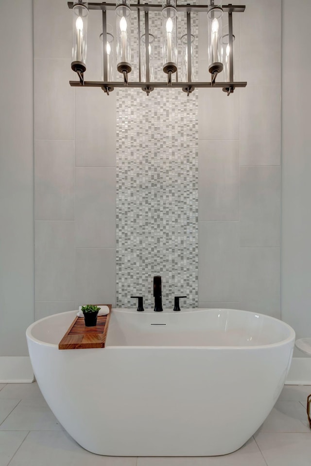 bathroom featuring tile walls, tile patterned floors, and a tub