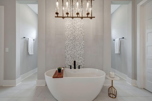 bathroom with a washtub, tile patterned floors, and tile walls