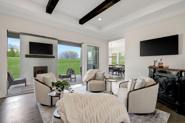 living room with dark hardwood / wood-style flooring, beam ceiling, and a fireplace