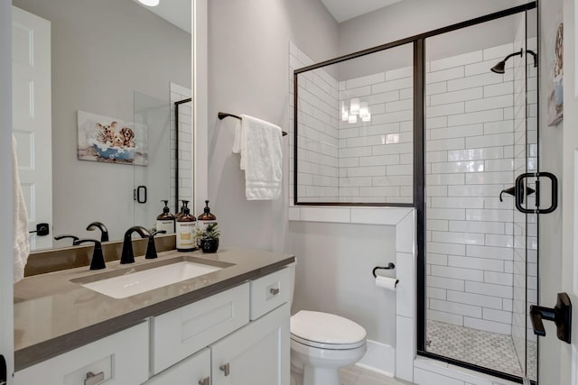 bathroom featuring vanity, walk in shower, and toilet