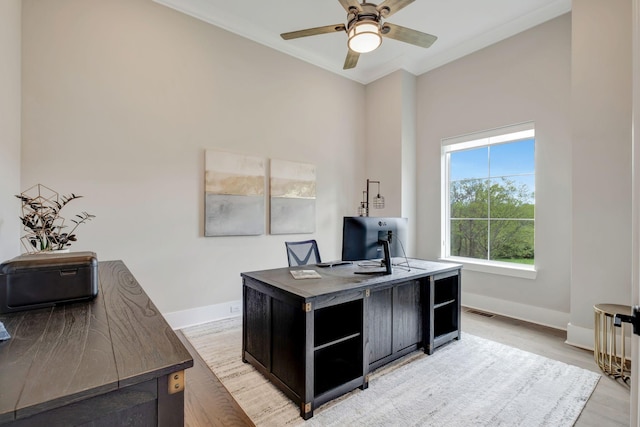 home office with hardwood / wood-style flooring, crown molding, and ceiling fan