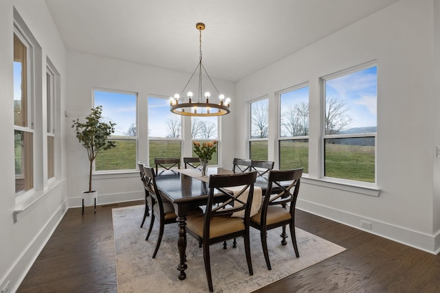 dining space featuring an inviting chandelier and dark wood-type flooring