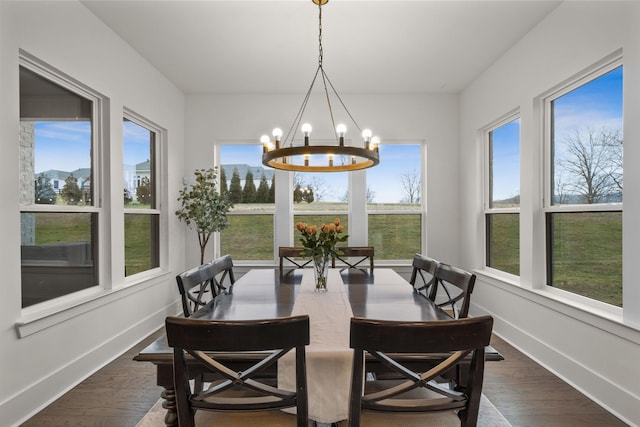 sunroom / solarium featuring an inviting chandelier and plenty of natural light