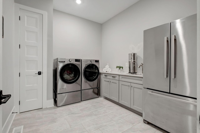 laundry room with washing machine and clothes dryer and sink